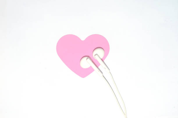 istock Headphones and pink heart-shaped CARDS on a white background 1133528749