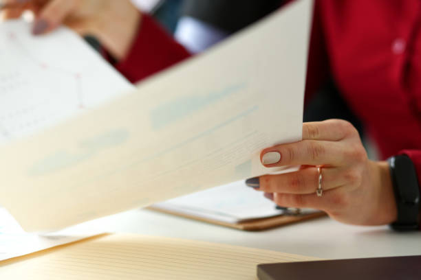 istock Group of people hold in arms financial papers solve and discuss problem 1133529403