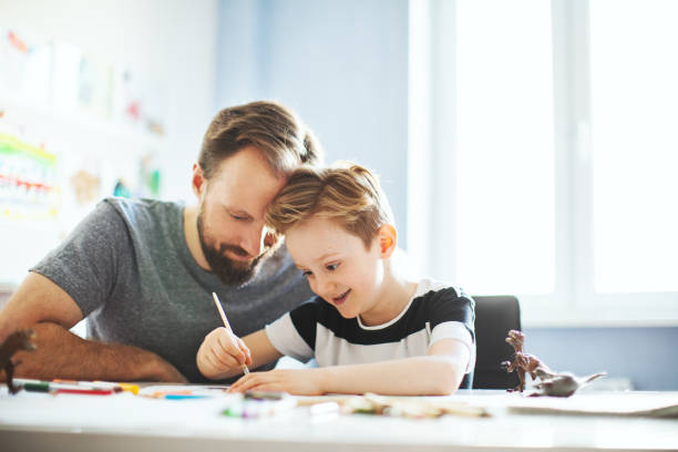 istock Father and son painting together 1133530239