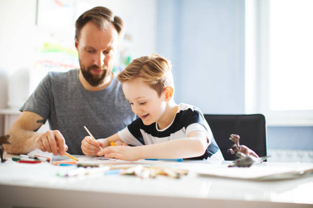 istock Father and son painting together 1133530248