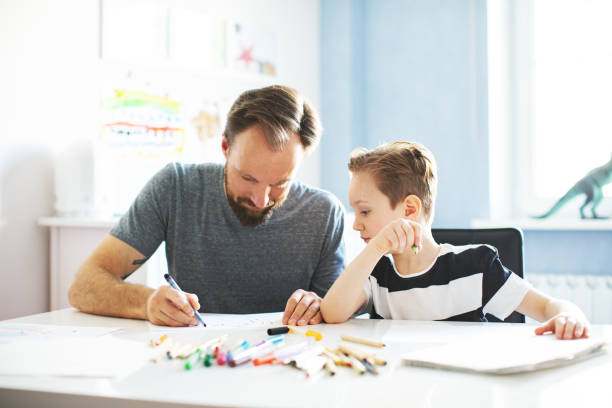 istock Father and son painting together 1133530272