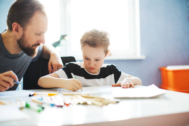 istock Father and son painting together 1133530284