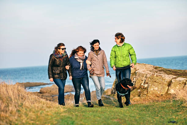 istock Friends walking by the sea 1133530358