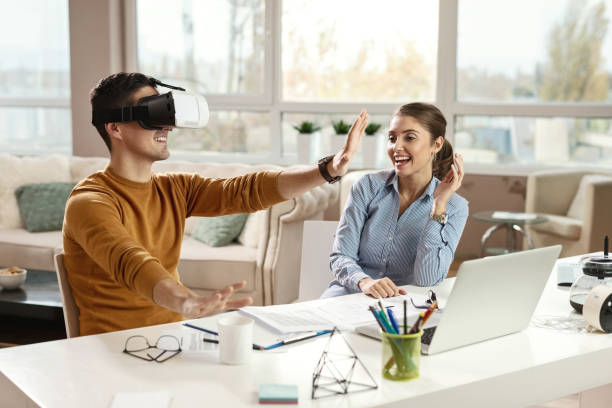 istock Playful business couple having fun with virtual reality headset. 1133530466