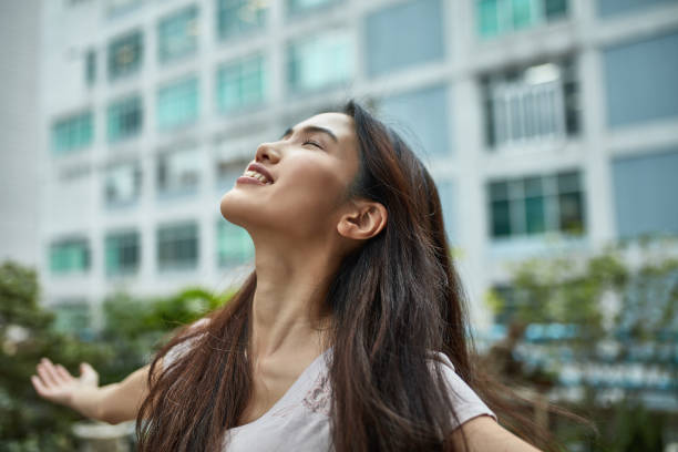 istock Smiling young woman with eyes closed at terrace 1133531199