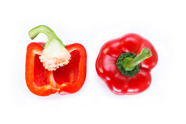 istock red bell pepper cut into pieces on white background, top view. 1133531240