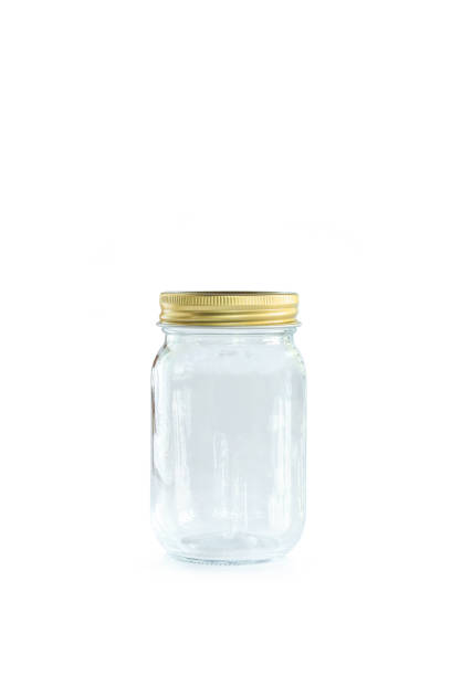 istock Empty jar of golden cap is closing on a white backgrond. 1133531404