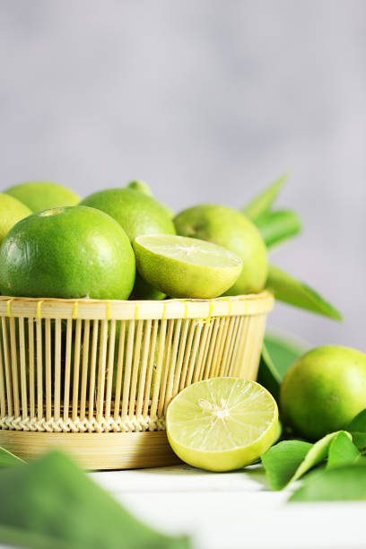istock Fresh limes on white wooden background. Green limes. 1133531449