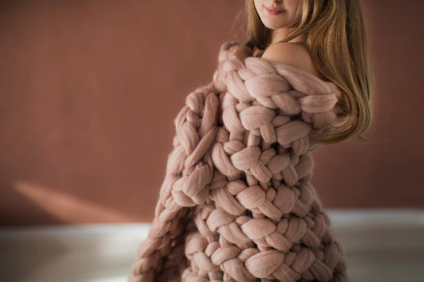 istock Woman covered in pink plaid posing in studio 1133532064