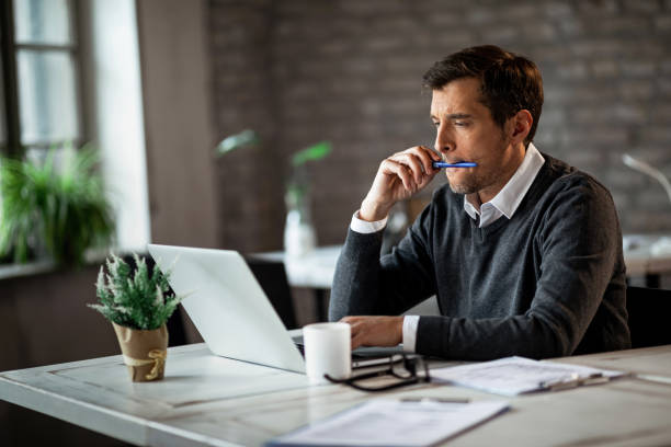 istock Concentrated businessman working on a computer at his office desk. 1133533374