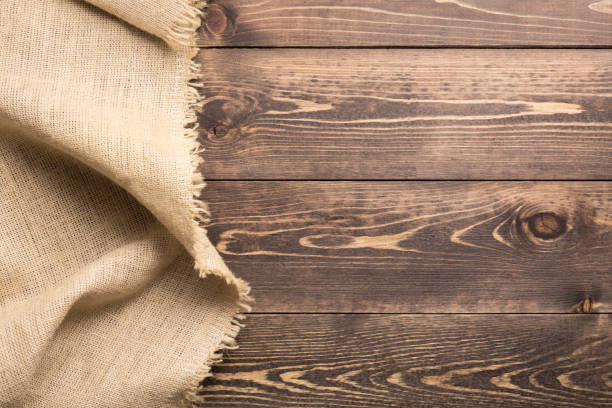 istock Burlap hessian sacking cloth on wooden table background with free space. 1133534538