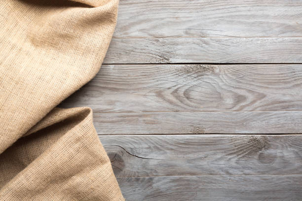 istock Burlap hessian sacking cloth on wooden table background with free space. 1133534541