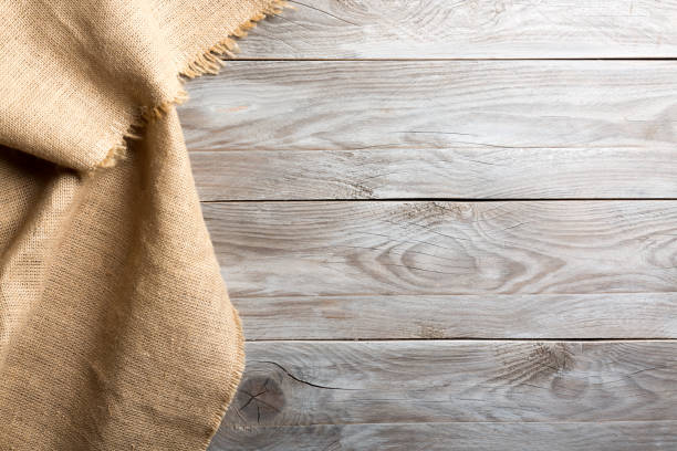 istock Burlap hessian sacking cloth on wooden table background with free space. 1133534543