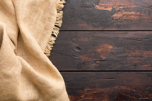 istock Burlap hessian sacking cloth on wooden table background with free space. 1133534545