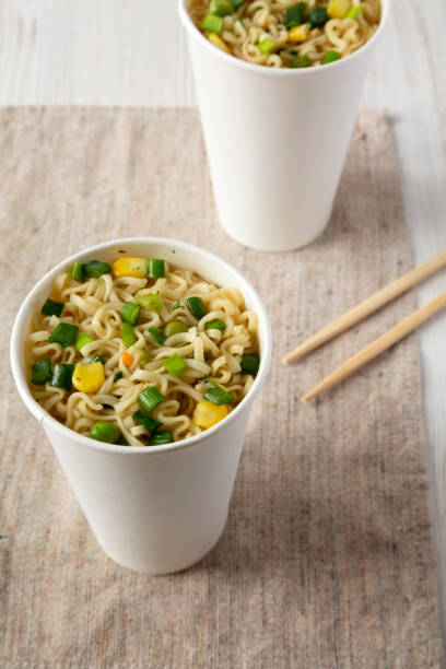 istock Cooked instant noodles with beef flavoring in paper cups, low angle view. Close-up. 1133534597