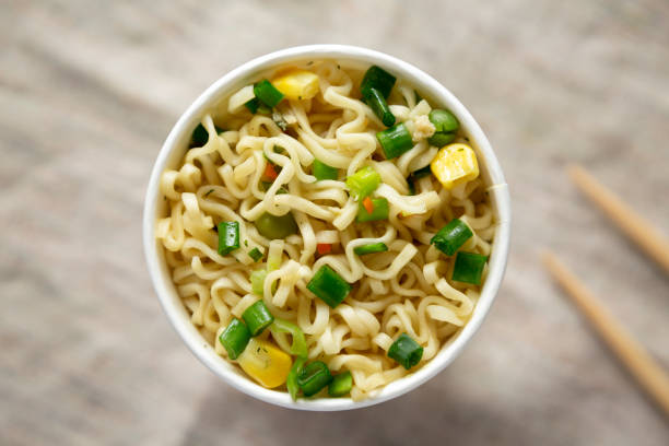 istock Top view, prepared instant noodles with beef flavoring in a cup. Flat lay, from above, overhead. Close-up. 1133535305
