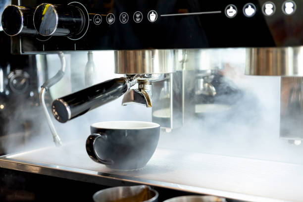 istock coffee cup latte art placed on coffee maker machine  steam in coffee shop cafe 1133535539