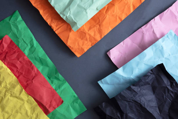 istock Wrinkled multicolored papers on gray background 1133536200