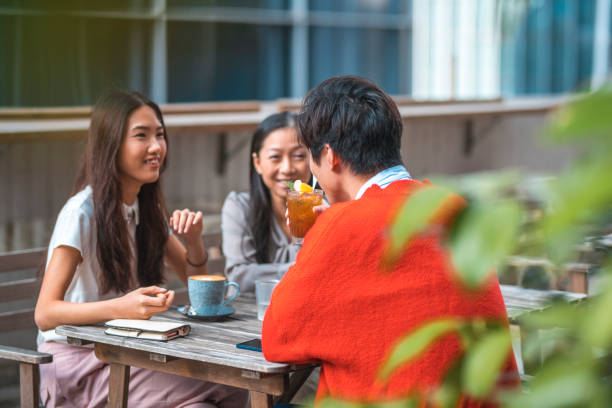 istock Friends talking while sitting at outdoor cafe 1133536399