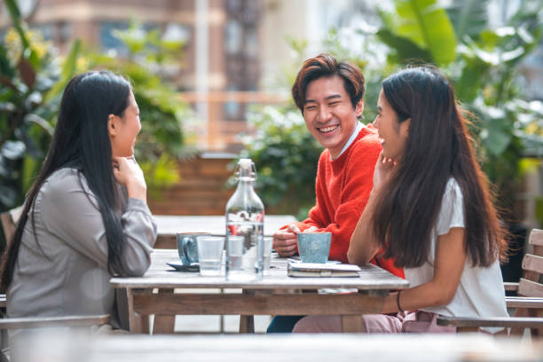 istock Friends talking while sitting at outdoor cafe 1133536427