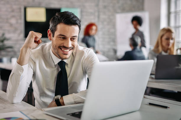 istock Happy entrepreneur celebrating success while working on laptop in the office. 1133536865