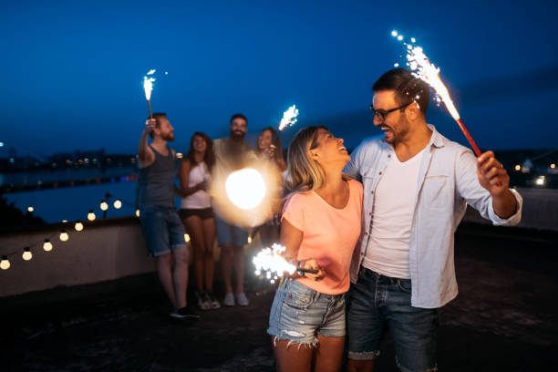 istock Happy friends lighting sparklers and enjoying freedom 1133538245