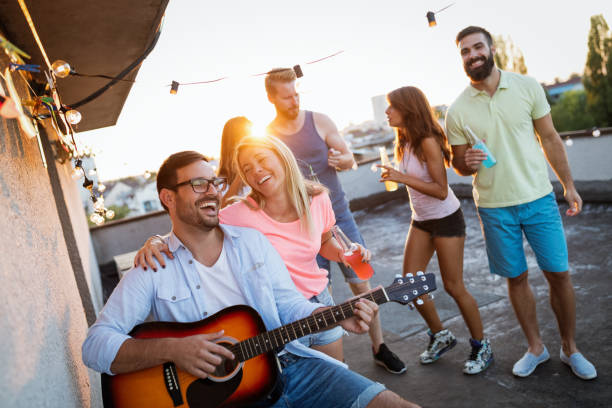 istock Young man playing guitar for friends and his girlfriend 1133538250