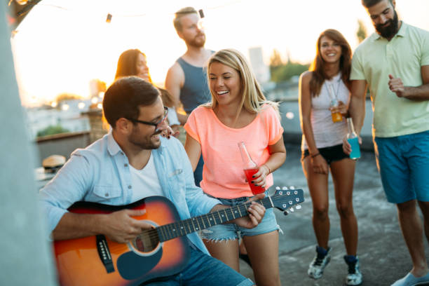 istock Group of happy friends having party on rooftop 1133538267