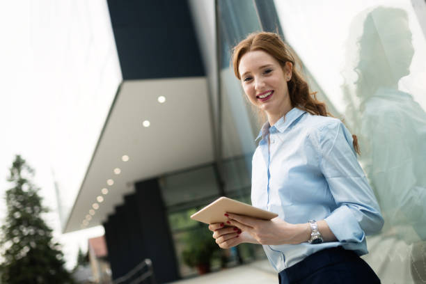 istock Attractive young businesswoman using digital tablet outside 1133539946