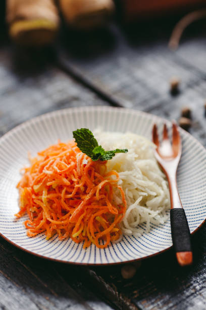 Healthy food variety vegetables and many fruits mixed on ceramic dish for cooking salad serve to thai customers people eating and drinking in dining room at restaurant cafe shop in Bangkok, Thailand