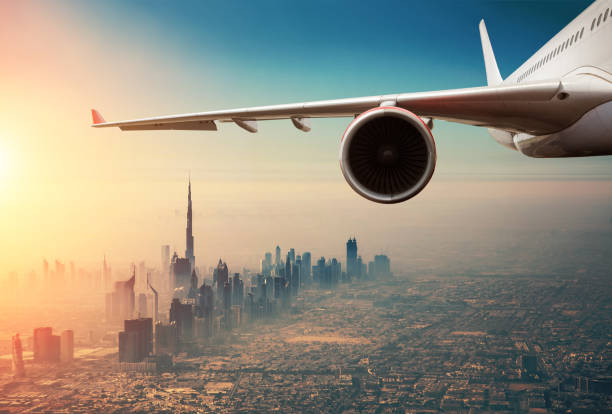 istock Commercial jet plane flying above Dubai city 1133545228