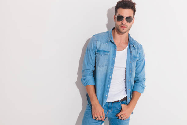 istock Attractive man posing while holding his thumb in the pocket 1133545415