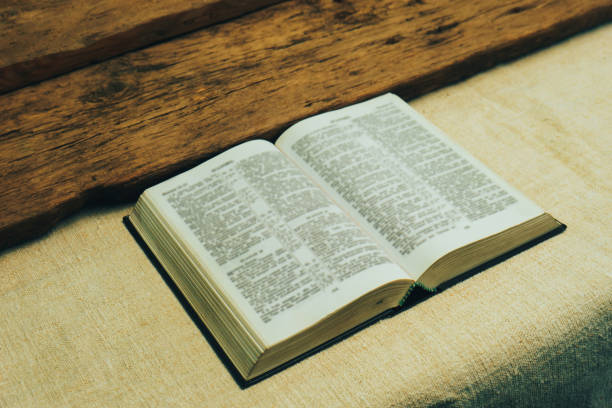 istock Open Holy Bible on a old  table. Beautiful background. Religion concept. 1133546835