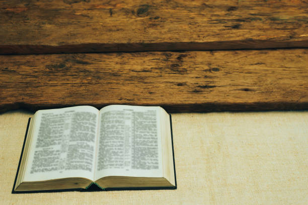 istock Open Holy Bible on a old  table. Beautiful background. Religion concept. 1133546946
