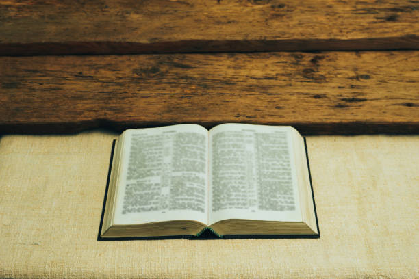 istock Open Holy Bible on a old  table. Beautiful background. Religion concept. 1133547090