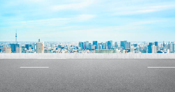 Empty asphalt road with tokyo skyline for mockup Business and design concept - Empty asphalt road with panoramic modern cityscape aerial view under bright blue sky of Tokyo, Japan for mockup horizon over land stock pictures, royalty-free photos & images