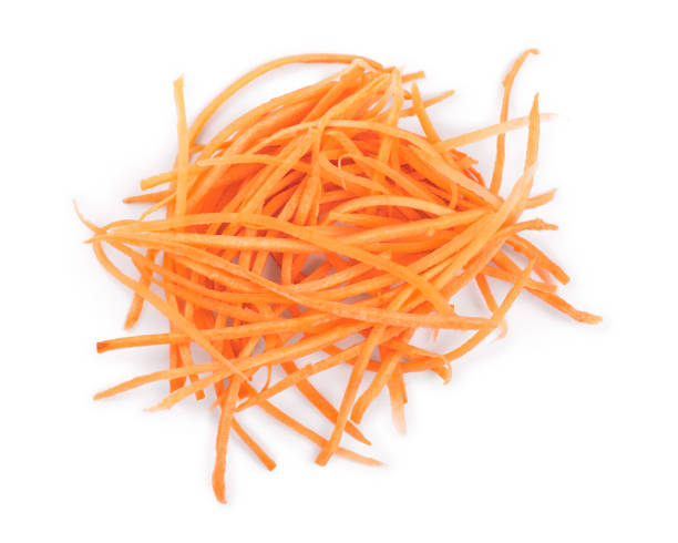 istock fresh shredded carrots isolated on white background, Top view. Flat lay 1133549577