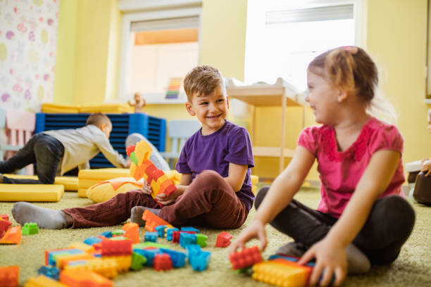istock Small kids playing with toy blocks at preschool. 1133549671