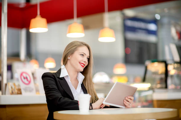 istock Young student studies with digital tablet in coffee shop 1133550480