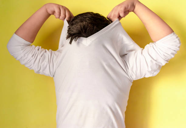 istock boy wearing white t-shirt on yellow background 1133552140