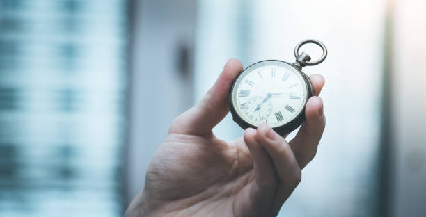 istock Time goes by: Man is holding a vintage watch in his hand, business context, copy space 1133553093