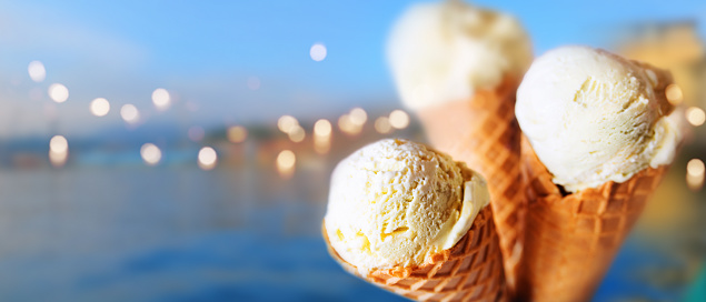 Various ice cream cones with mediterranean background and bright bokeh