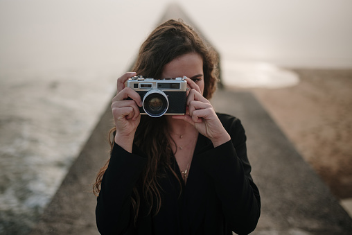 Young woman using a vintage camera