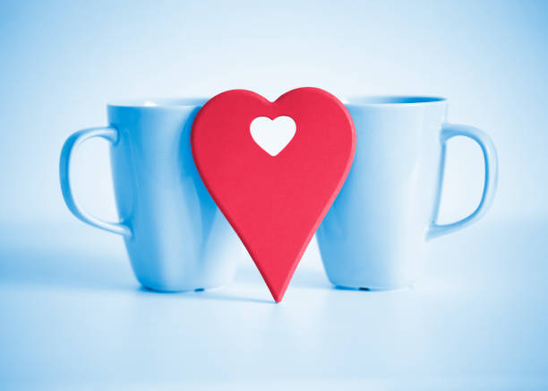 Red heart in front of two blue cups