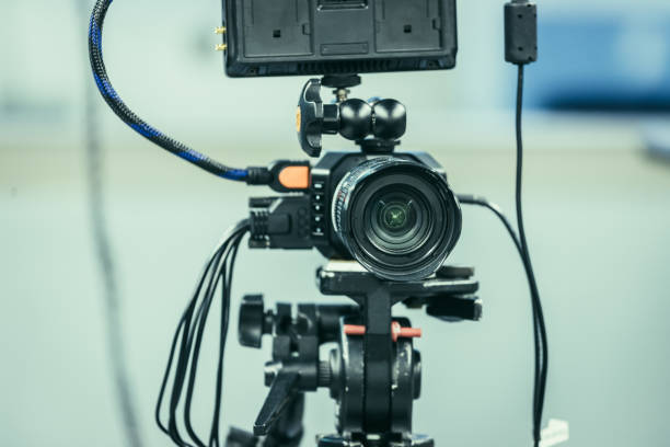 istock Modern film camera on a tripod in a broadcasting studio, spotlights and other equipment 1133559951
