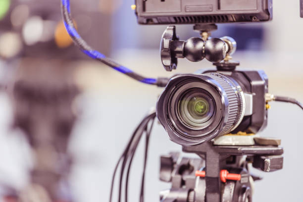 istock Modern film camera on a tripod in a broadcasting studio, spotlights and other equipment 1133559952