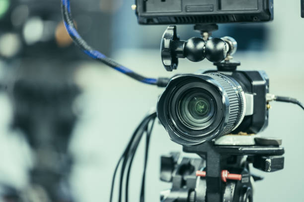 istock Modern film camera on a tripod in a broadcasting studio, spotlights and other equipment 1133559953