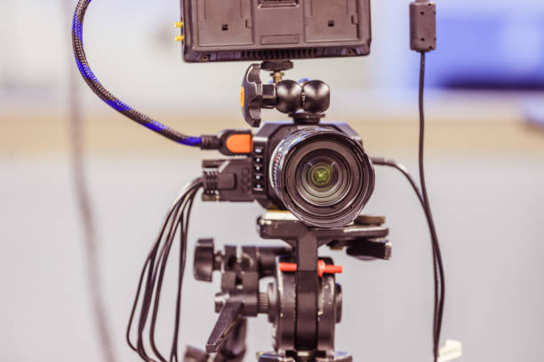 istock Modern film camera on a tripod in a broadcasting studio, spotlights and other equipment 1133559955