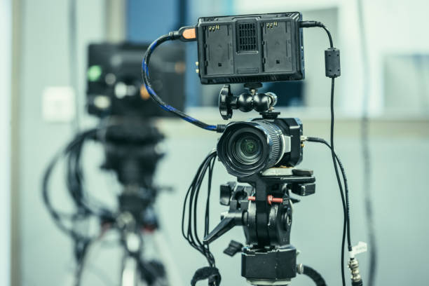 istock Modern film camera on a tripod in a broadcasting studio, spotlights and other equipment 1133559967