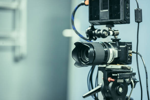 istock Modern film camera on a tripod in a broadcasting studio, spotlights and other equipment 1133559973